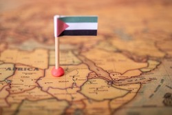 The flag of Sudan on the world map. The concept of travel and tourism.