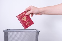 Passport of the Russian Federation in a trash can. The man throws the passport into the trash. Change of citizenship and country of residence.