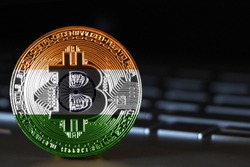 Bitcoin close-up on keyboard background, the flag of India is shown on bitcoin.