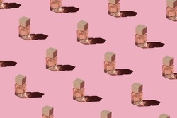 Fragnance parfume pattern. Miniature bottles of pink woman perfume on a pastel pink background, top view. Mockup of fragrance perfume. Trendy sunlight minimal concept.