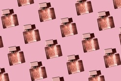 Fragnance parfume pattern. Bottles of pink woman perfume on a pastel pink background, flat lay, top view. Mockup of fragrance perfume. Trendy sunlight minimal concept.