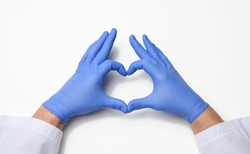 two male hands in blue latex sterile medical gloves shows a gesture of the heart on a white background, concept of goodness, help and volunteering