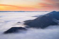 Sunrise as seen atop Boroka Lookout in the Grampians National Park in Victoria, Australia. A large amount of fog had rolled in before dawn and the sunrise illuminated the amazing landscape below.