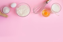 Frame of food ingredients for baking on a gently pink pastel background. Cooking flat lay with copy space. Top view. Baking concept. 