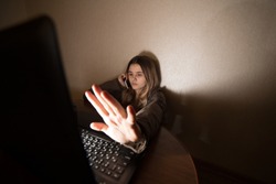 Teen girl excessively sitting at the computer laptop at home. he is a victim of online bullying Stalker social networks.Too much work sleepy stressed young woman