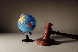 Wooden Judge gavel and globe. International environment law concept