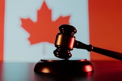 Gavel and Flag of Canada in the background.
