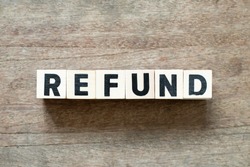 Letter block in word refund on wood background