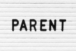 Black alphabet letter in word parent on white felt board background