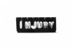 Black color banner that have embossed letter with word injury on white paper background