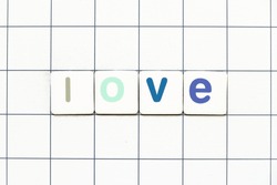 Colorful tile letter in word love on white grid background