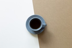 Gray cup of coffee on brown and white background. flat lay, top view, copy space
