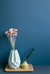 Vase of dry flowers on table. navy blue wall background. home interior decor