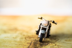 Travel Concept. Close up of motorcycle toy on map.