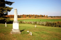 Historic church cemetery. Rural countryside. Country. Pasture. Woods. Fall. Autumn. Monument. Fence. Cornfield. Farm. Pasture. Graveyard. History. Pastoral. Peaceful.