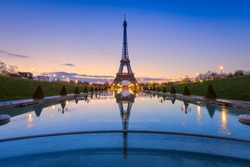 Frozen reflections in Paris. Eiffel Tower at sunrise from Trocadero Fountains 