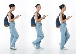 Walking with cell smart phone Full length Figure snap of 20s Asian Woman black hair vast jeans pant and sneaker. Casual beautiful Female walk with backpack over white Background isolated