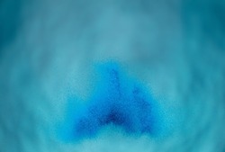 Small Fine size Sand flying explosion, Blue Ocean wave explode, abstract cloud fly. Turquoise colored sand splash throwing Air. Underwater wallpaper background high speed shutter, freeze stop motion