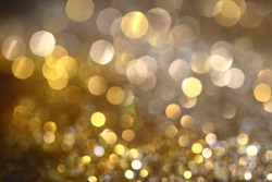 Abstract Golden Bokeh background with shining defocus sparkles. Blurred Glitter Dust Macro close up, copy space for text logo