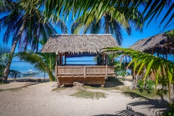 Bamboo bungalow on the beach among palm trees. Coron island, Philippines