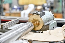 Machine lead screw with bronze nut for equipment repair.