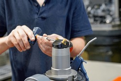 A worker changes a high speed insert on a milling cutter to work on a CNC milling machine.