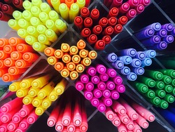 Colored pens on shelves In the shop,Office supplies and stationery. Colorful pens arranged on shelves selling stationery. Multicolored markers in art store. Art, workshop, craft, creativity concept.