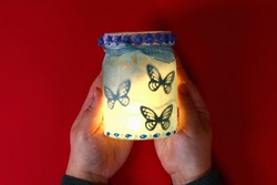 Diy Fairy Jar on red background. Gift ideas, decor February 14, St Valentines Day, love. Handmade Lamp, nightlight lantern glass jar, napkin, glue, glitter. Step by step. Process crafts. Top view