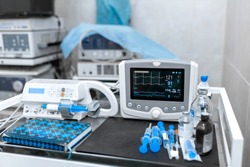 Cardiac monitor and syringe at operating table. Pet surgery.