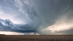 Storm clouds rotating in the sky over the plains in Nebraska during tornado warning.