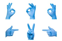 Ok and V signs are showed by man hand in a blue medical glove on a white background. Okay. The symbol of Victory. Victory over a virus.