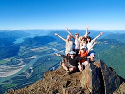Successful Group of Happy Friends on Mountain Top, Cheering. 
Mount Cheam Summit,  British Columbia, Canada. 