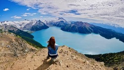 Woman doing yoga above alpine lake. Panorama Ridge. Garibaldi Lake. Garibaldi Provincial Park. Whistler. British Columbia. Canada.