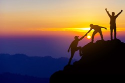 Teamwork friendship  hiking help each other trust assistance silhouette in mountains, sunrise. Teamwork of two men hiker helping each other on top of mountain climbing team beautiful sunrise landscape