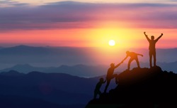 Teamwork helping hand trust assistance silhouette in mountains, sunset. Team of climbers man hiker, help each other on top of mountain, Business concept.