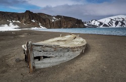Whaling boat, half buried, in volcanic mud flow; Deception Island, South Shetlands