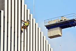 Construction worker and white facade building