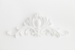Expensive interior. Stucco elements on light luxury wall. White patterned. Mouldings element from gypsum. Roccoco style