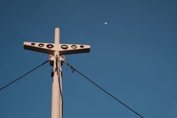 low angle ship mast clear sky and moon