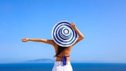 Summer blue trend with young woman in hat at  happy freedom lifestyle in Aegean sea mediterranean at Santorini,greece