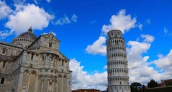 View of Cloudy blue sky in Pisa Cathedral (Duomo di Pisa) with Leaning Tower  (Torre di Pisa) Tuscany, Italy.The Leaning Tower of Pisa is one of the main landmark in Italy.