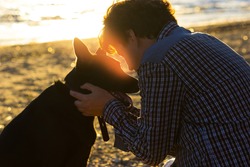 man and his dog on the beach. best friends