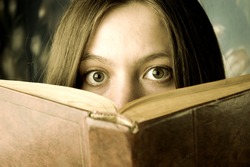 scared girl with a book, reading horrors