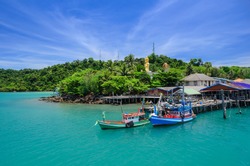 A blue sky and emerald sea landscape at Ao Salat bay boat pier on Koh Kood island in Gulf of Thailand
