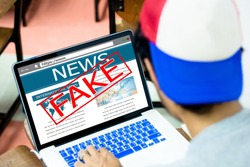 Fake news, HOAX concept.Young man using laptop or computers