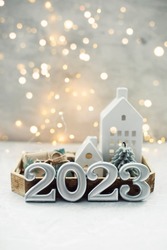 Christmas and New Year card. Number 2023 on holiday background. Christmas lights bokeh background. Holiday postcard. Happy New Year 2023 Card Concept