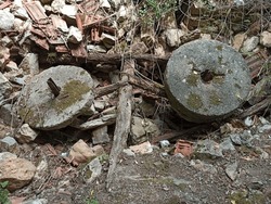 collapsed mill debris. millstones. ruined old village mill. ruin