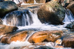 Close up of water falling through rocks on the course of a creek in Uvas Canyon County Park, Santa Clara county, California; long exposure