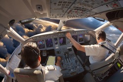 Cockpit of a modern passenger aircraft. The pilots at work.