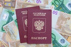 Two  Russian passports are on the background of euro banknotes. passports are intended for travel outside of Russia. Europe travel concept